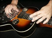 Resonator guitar played lap steel fashion.