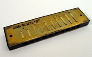 Reedplate mounted on the comb of a diatonic harmonica.