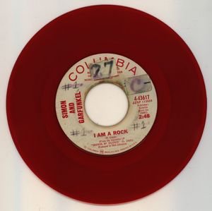 A red vinyl promotional copy of Simon & Garfunkel's single "I Am A Rock," from 1966.